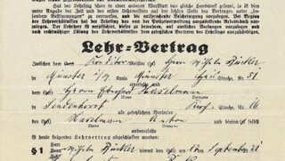 Das Bild zeigt einen historischen Lehrvertrag der Handwerkskammer zu Münster mit handschriftlichen Eintragungen und Stempeln.